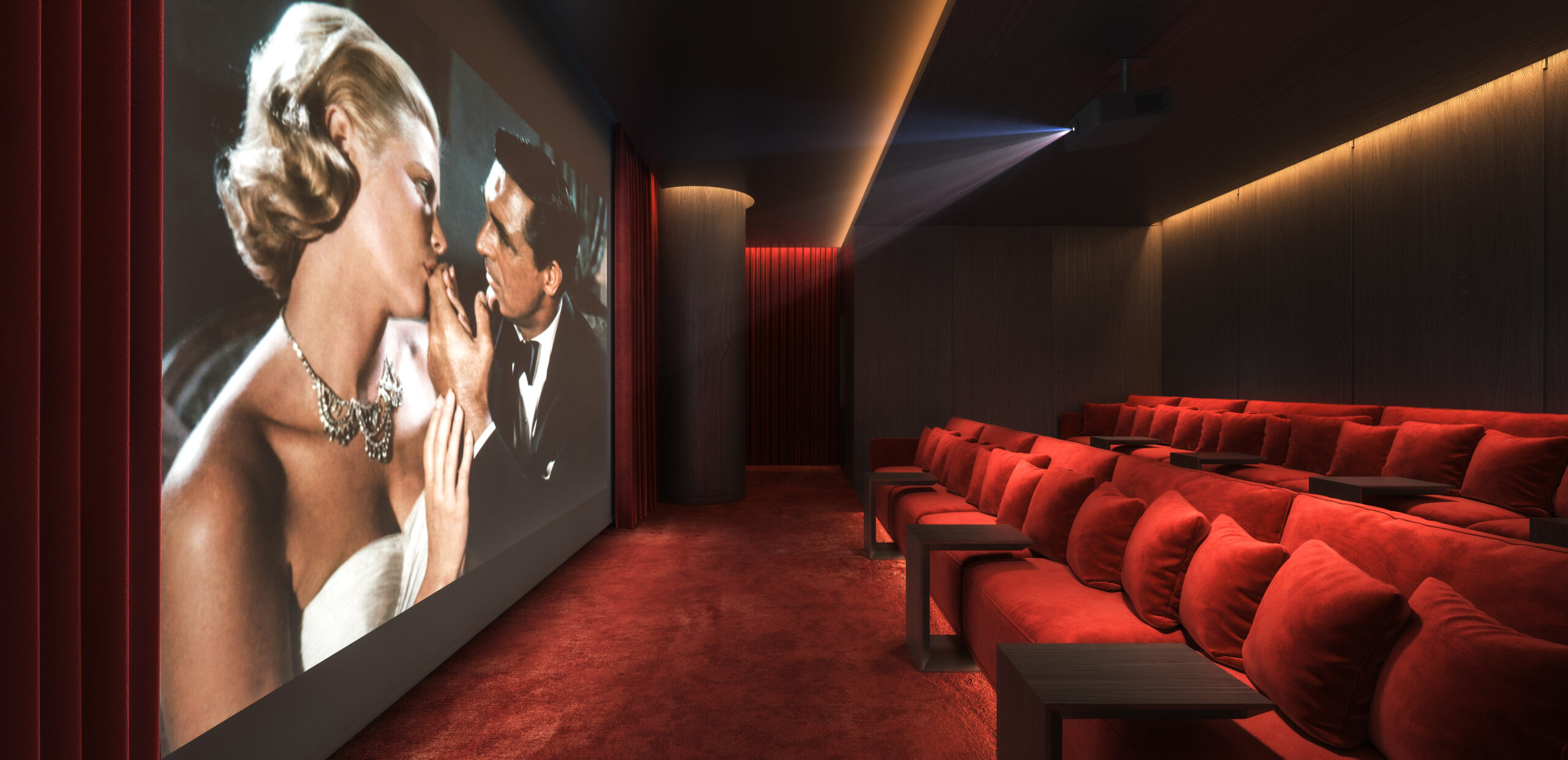 A cinema hall with minimum sitting arrangement of red furniture.
